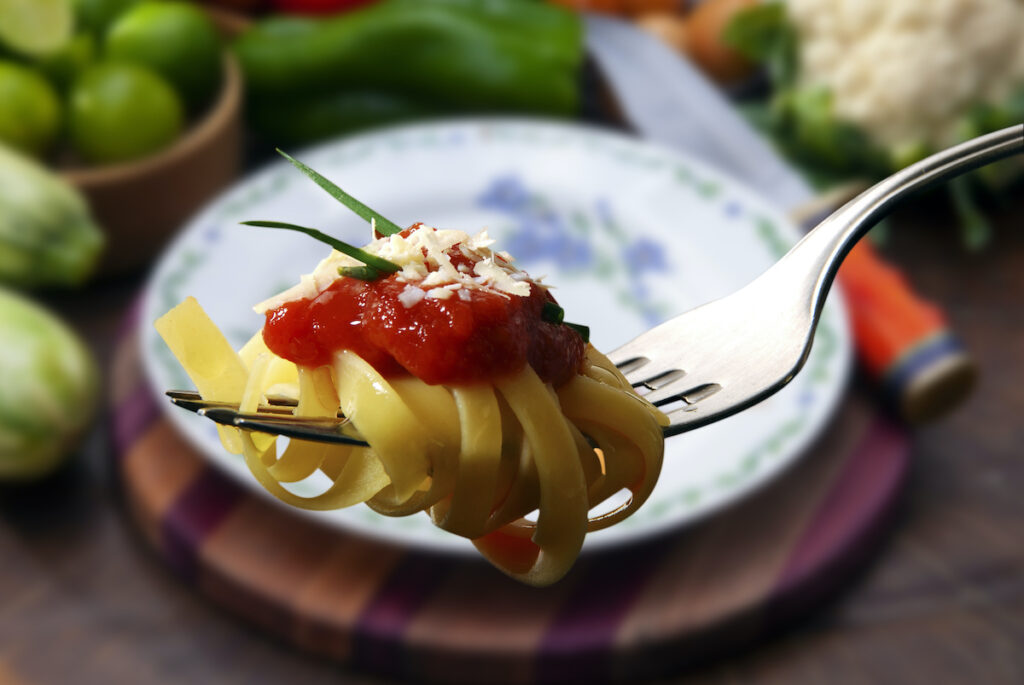 Pasta with tomato sauce on fork
